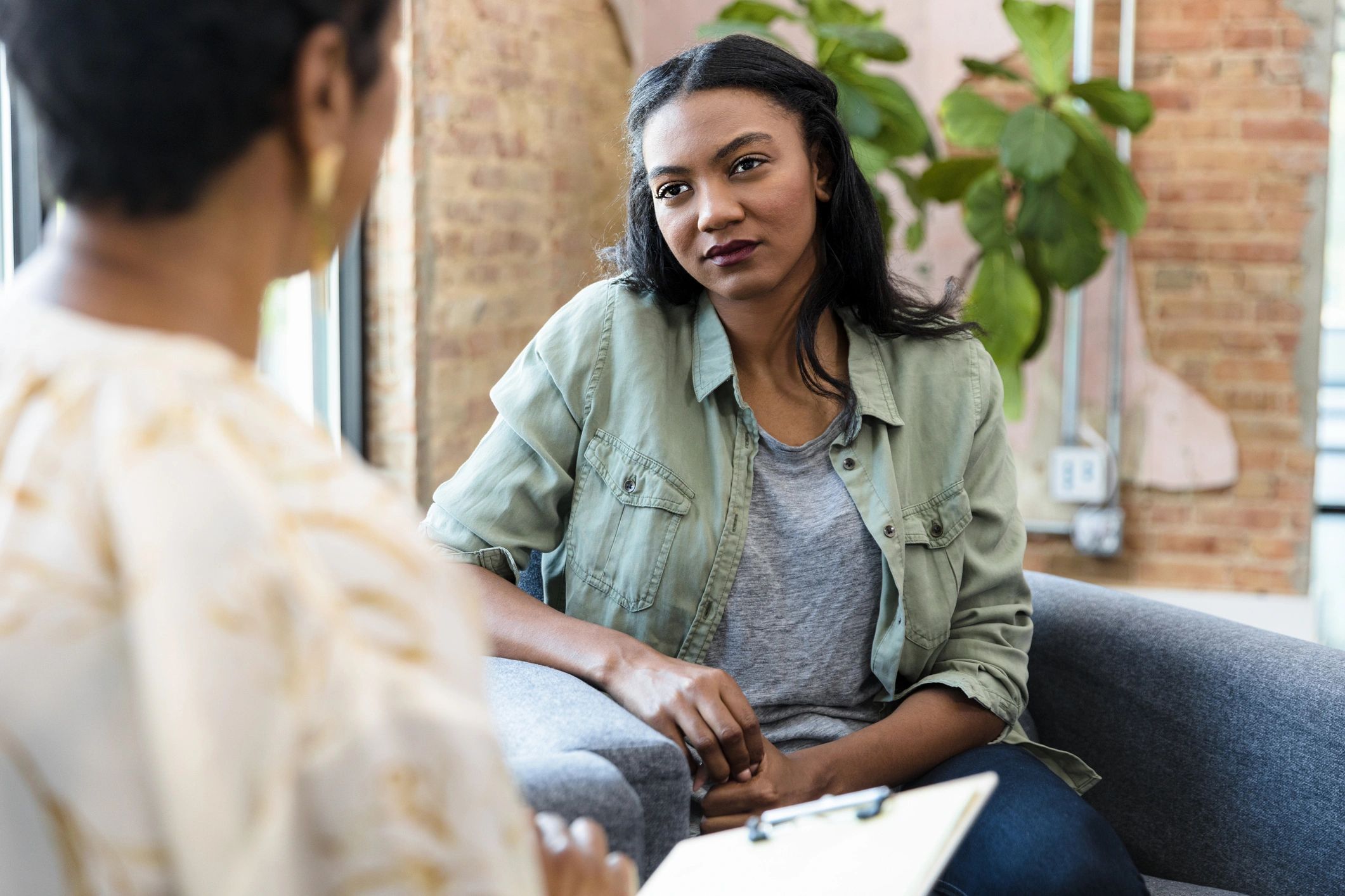 Woman speaking with a therapist in a calm office