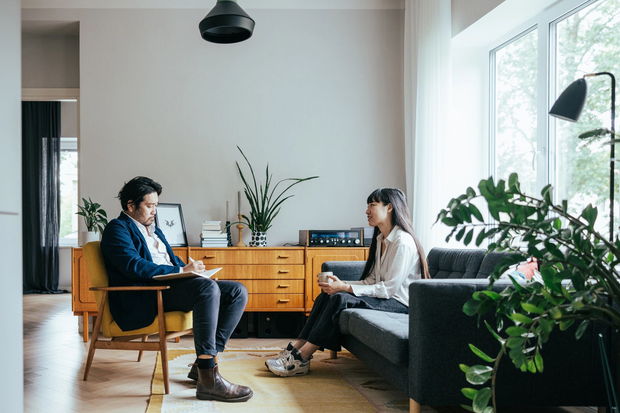 Therapist and client in a supportive conversation in a cozy office