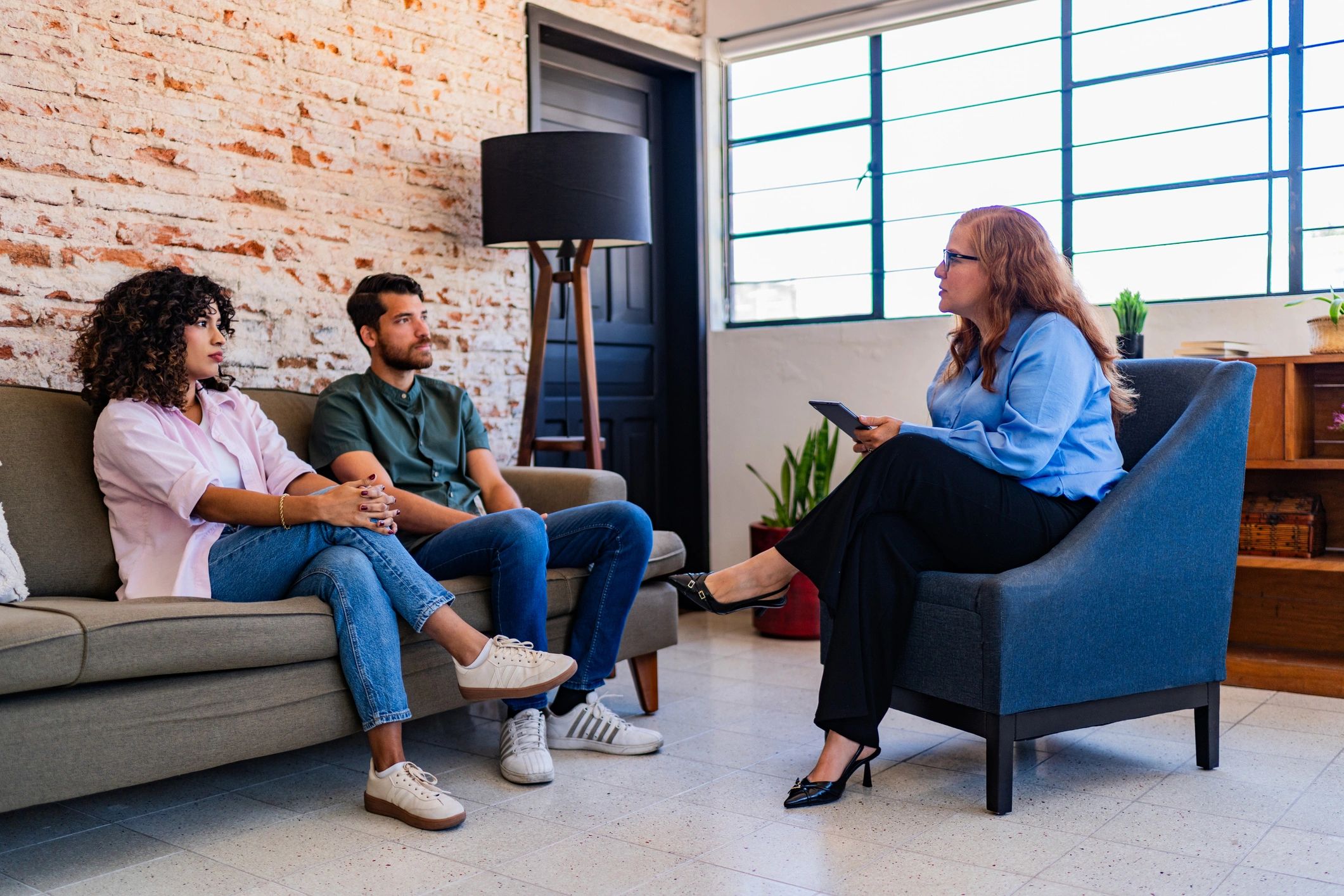 Couple speaking with a therapist during a counseling session